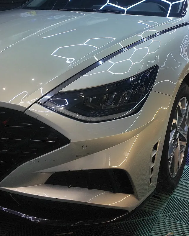 Pearl-white Hyundai Sonata reflecting the hexagon lights before its color change to gloss black with PPF film at JU Riyadh Center