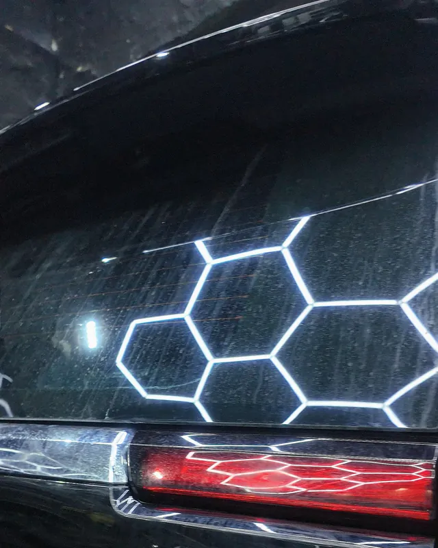 Tail lamp and glass of a black 2025 GMC Yukon reflecting the hexagon lights, full-body clear gloss PPF at JU Riyadh Center