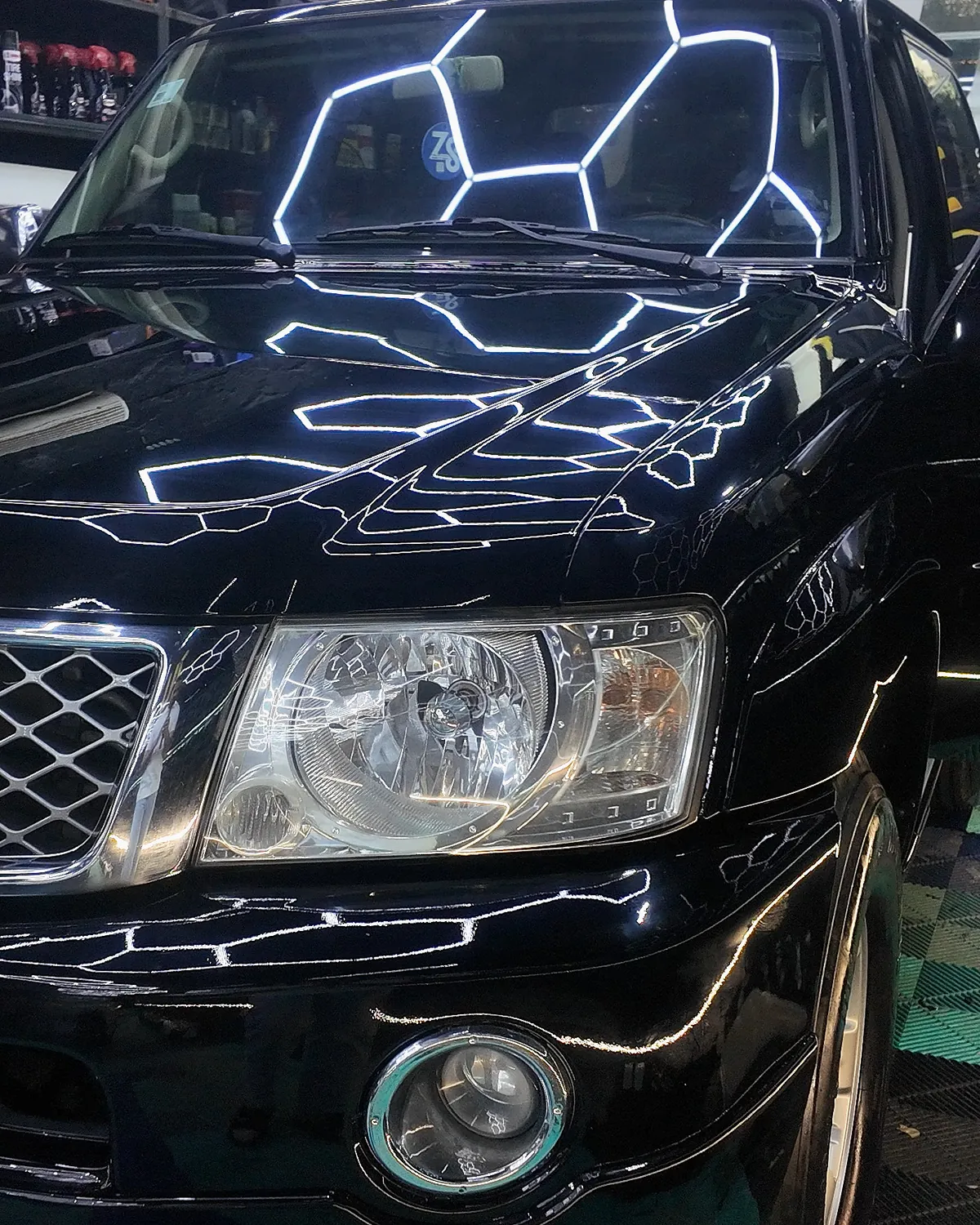 Front of the Nissan Patrol Super Safari after its color change from white to gloss black with PPF film at JU Riyadh Center